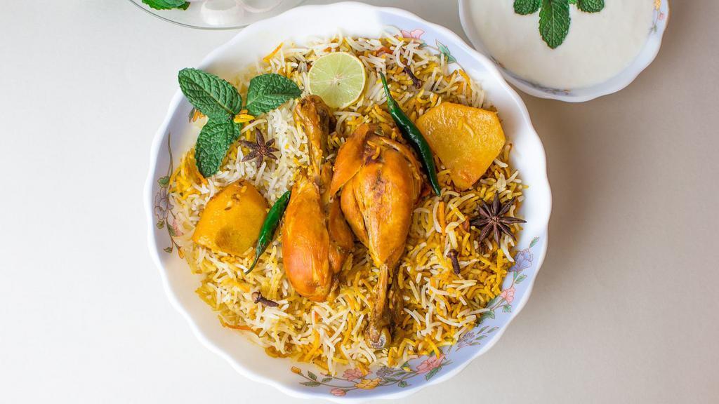 Chicken Dum Biryani · Fragrantly seasoned rice mixed with chicken and baked in a clay pot.