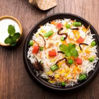 Vegetable Dum Biryani · Fragrantly seasoned rice mixed with fresh seasonal veggies.