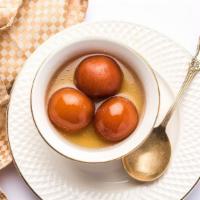 Gulab Jamun · Two pieces of sweet dumpling in a sugar syrup.