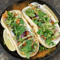 Bombay (Naan Tacos) · Two mini garlic naans with masala marinated chicken in lemon, garlic white sauce, red onions...