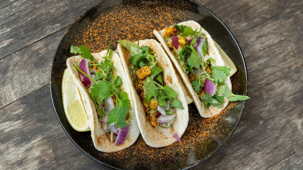 Masala Cauliflower (Street Tacos) · Masala marinated cauliflower, red onions, mint sauce and fresh cilantro, three tacos. (Spicy Gobi)