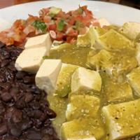 Tofu Rancheros · Vegan. Cubed tofu on two grilled corn tortilla drenched in salsa verde with pico de gallo an...