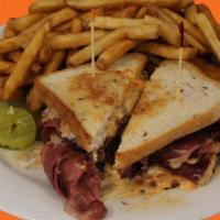 Classic Reuben · Sliced corned beef, melted swiss cheese, Thousand island, and sauerkraut on grilled rye.