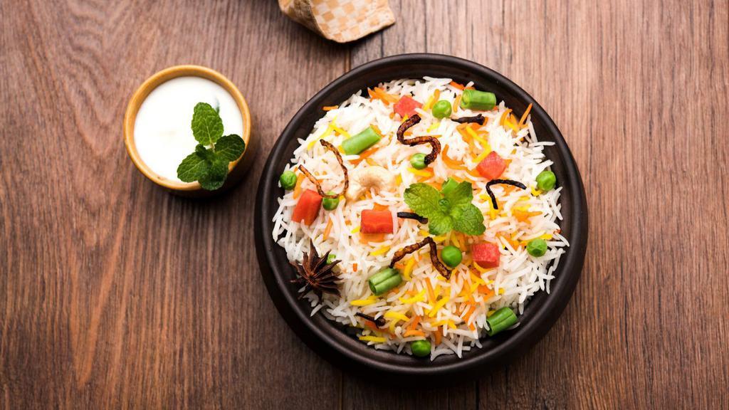 Vegetable Biryani · Marinated basmati rice cooked with famers market seasonal vegetables.