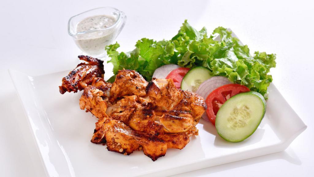Chicken Boti Kabab · Boneless chicken marinated in yogurt and Indian spices cooked in the clay oven.