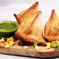 Veggie Samosas · Two crispy pastries filled with potatoes, peas and ginger garlic.