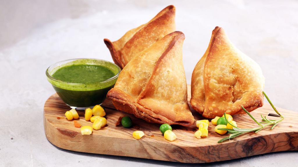 Veggie Samosas · Two crispy pastries filled with potatoes, peas and ginger garlic.