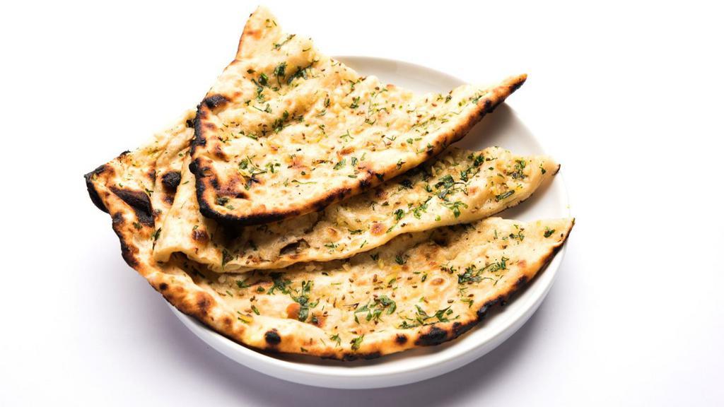 Garlic Naan · Elegant and soft garlic battered tandoor naan made to perfection
