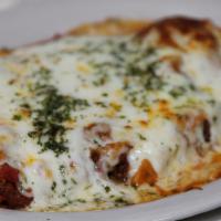 Chicken Parmigiana · Breaded, pan-fried, and baked in marinara sauce topped with mozzarella cheese.