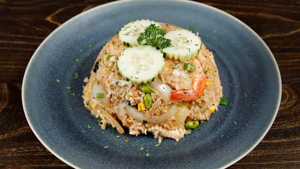 Pineapple Fried Rice · Egg, pineapple, pea, carrot, onion, cashew nut, and cranberry with yellow curry powder
