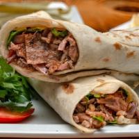The Chicken Shawarma Wrap · Sizzling strips of chicken shawarma, lettuce, tomatoes, onions, tzatziki and tahini sauce wr...