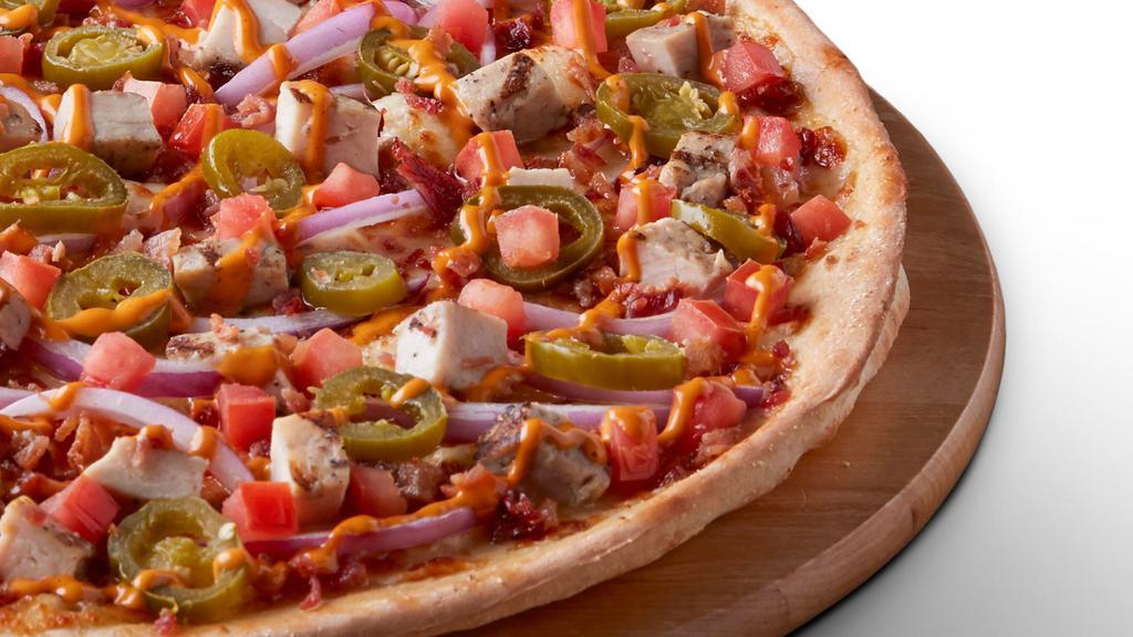 Chipotle Chicken - Large · Signature garlic white sauce on our Tuscany thin crust, topped with mozzarella cheese, all-natural grilled chicken, bacon bits, jalapeños, fresh tomatoes, red onion, and a chipotle sauce drizzle.