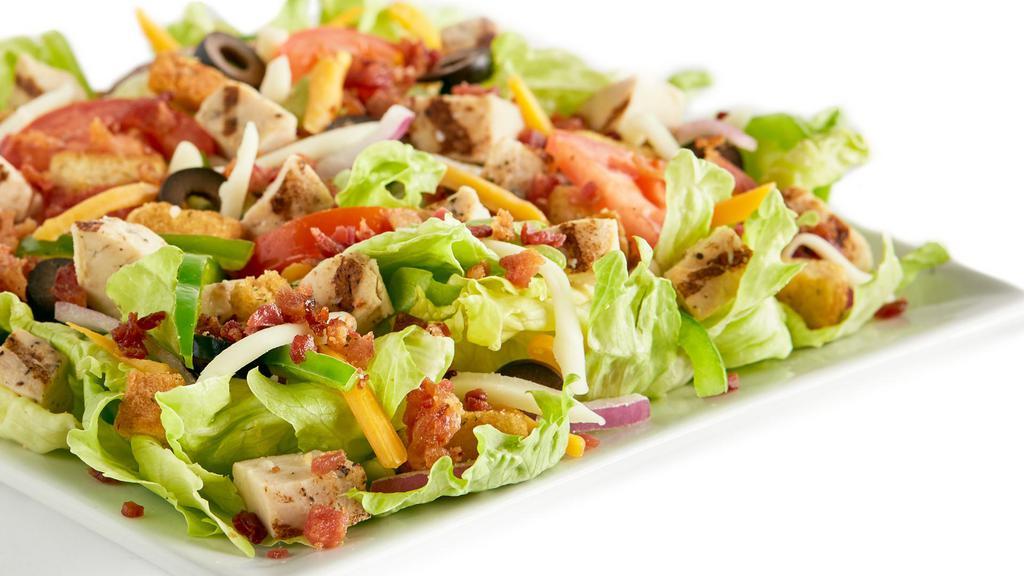 Chicken Bacon Ranch · Iceberg lettuce, bacon, all-natural grilled chicken, bell peppers, red onions, black olives, fresh Roma tomatoes, mozzarella cheese, cheddar cheese, seasoned croutons, and ranch or your choice of dressing.
