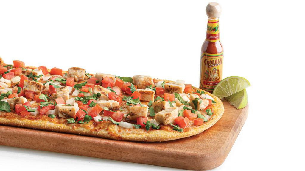 Street Taco Flatbread  · Taco sauce, mozzarella cheese, taco seasoning, all-natural grilled chicken, fresh diced tomatoes, sliced yellow onions, and fresh chopped cilantro. Comes with a complimentary side of lime and Cholula hot sauce.