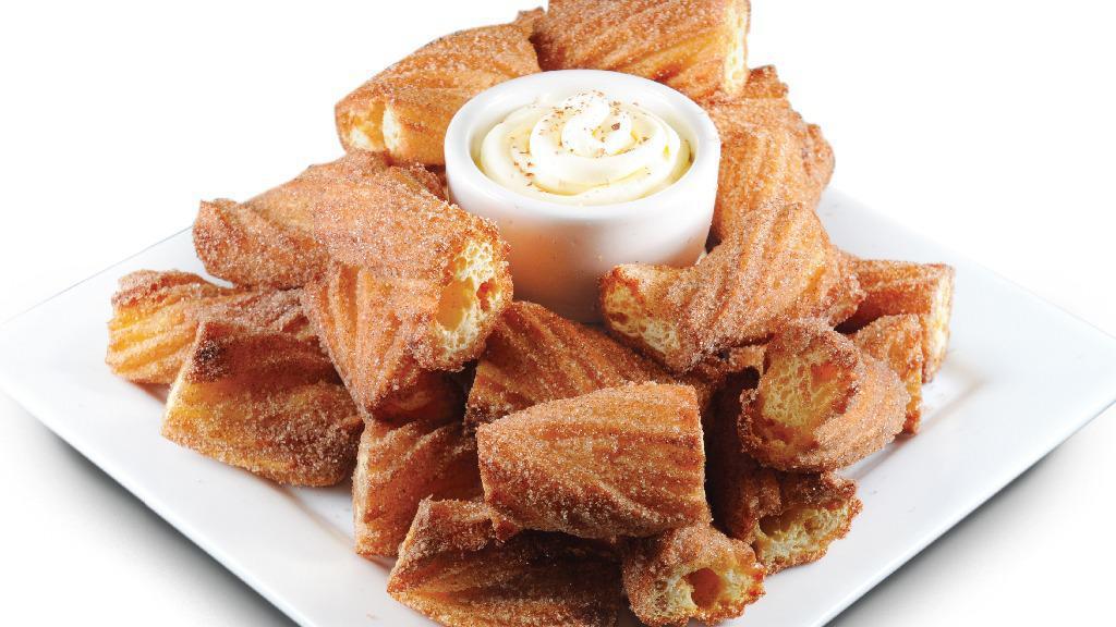 Cinna-Twist · 16 pieces of freshly-baked pastry dough, coated in a cinnamon-sugar mixture and served with creamy vanilla icing.