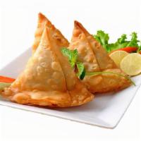 Vegetable Samosas · Two crisp vegetable puffs filled with potatoes, peas, and spices.