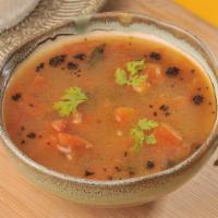 Rasam · Aromatic Indian soup simmered with tamarind juice and mild spices.