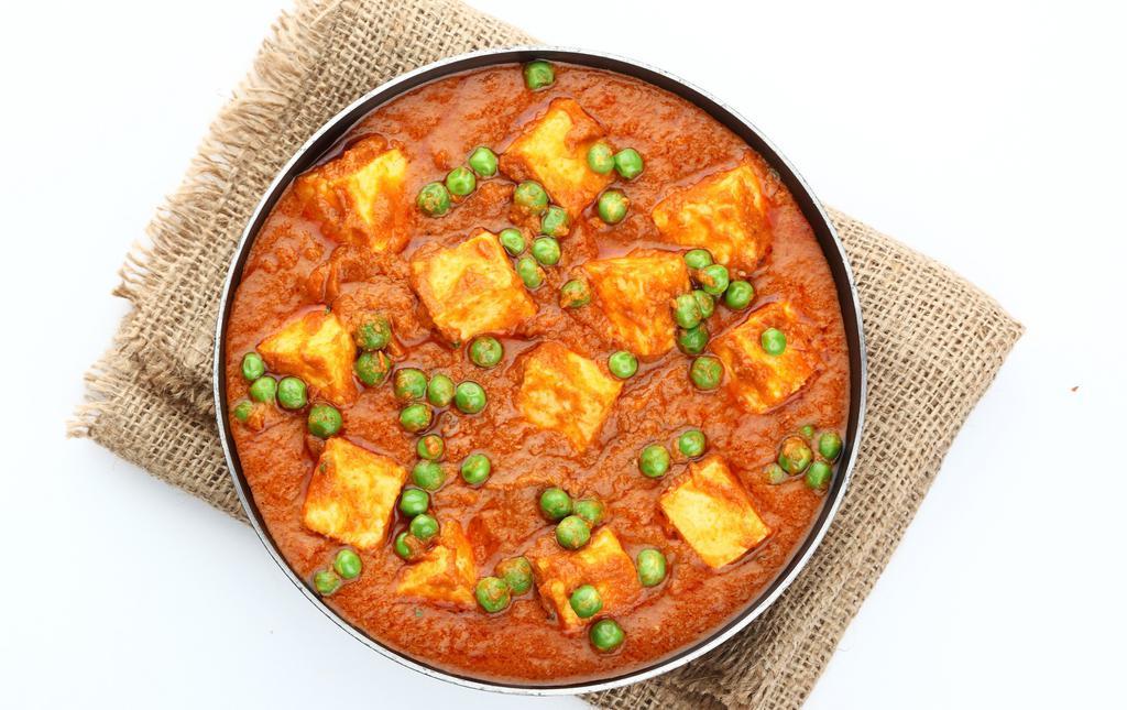 Mutter Paneer · Green peas and homemade Indian cottage cheese cubes cooked with thick curry sauce.