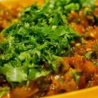 Baingan Bharta · Eggplant and green peas, onions and tomatoes cooked in mild spices.