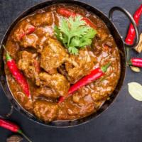 Goat Curry · Tender goat meat with bone, cooked in ginger, garlic and tomato sauce.