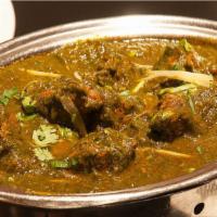 Gongura Goat · Goat meat with bone cooked with sour leaves, served as thick gravy
