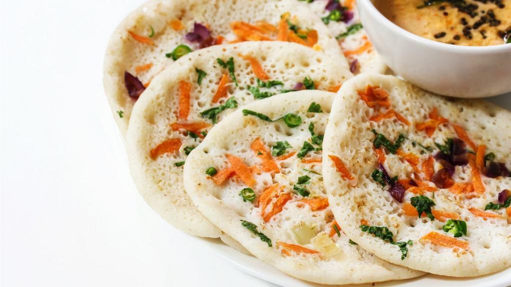 Onion Chili Dosa · Thin crispy crepe with a touch of onion and chili.