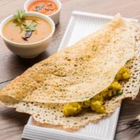 Rava Masala Dosa · Thin and crispy crepe made with wheat cream and rice flour, filled with potato curry.