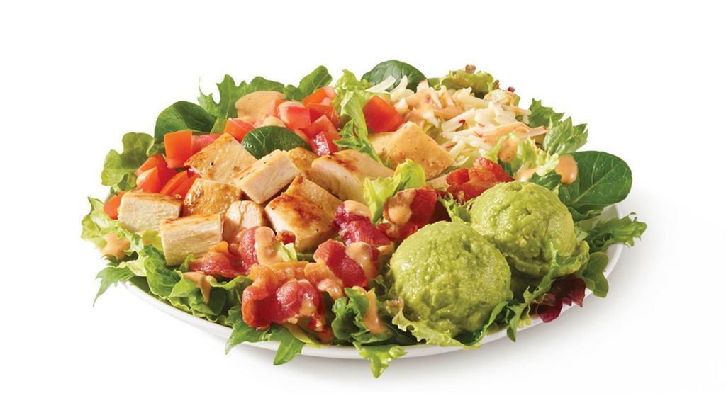 Southwest Avocado Salad · Made fresh daily with Wendy’s signature lettuce blend, pepper jack cheese, diced tomatoes, cool, creamy avocado, Applewood smoked bacon, and grilled chicken breast hot off the grill, all topped with Marzetti® Simply Dressed® Southwest Ranch Dressing. It’s zesty and Southwesty!