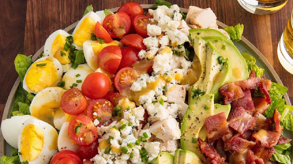 Cobb Salad · Mixed Greens, Grilled Chicken, Avocado, Hard Boiled Egg, Crispy Bacon, Tomato, Cucumber, Crumbled Blue Cheese, Herb Ranch Dressing.