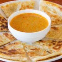 Palata and Dip · Multi layered bread with coconut chicken curry sauce or vege dip.