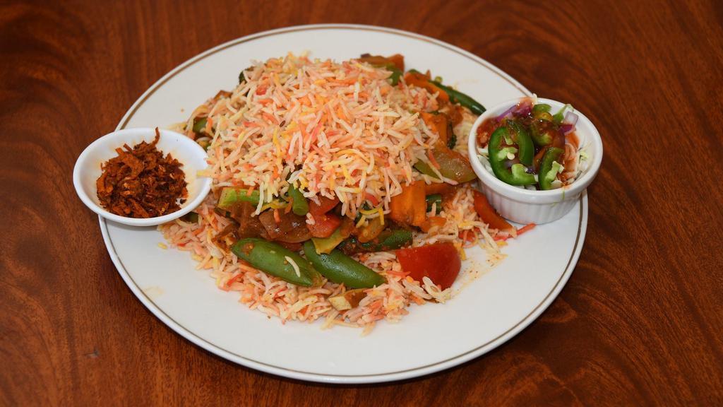 Vegetarian Dan Bauk · Biryani rice baked with all sorts of vegetables, raisins, cashew nuts & spices in a big pot.