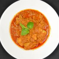 Chicken Curry · Burmese traditional chicken curry cooked with garlic ginger, onion and paprika.