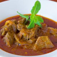Goat Stew · Slow cooked goat meat with onion, garlic, ginger and paprika.