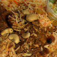 Beef Biryani · Beef buried in a big pot baked with biryani rice, raisins and cashew nuts.