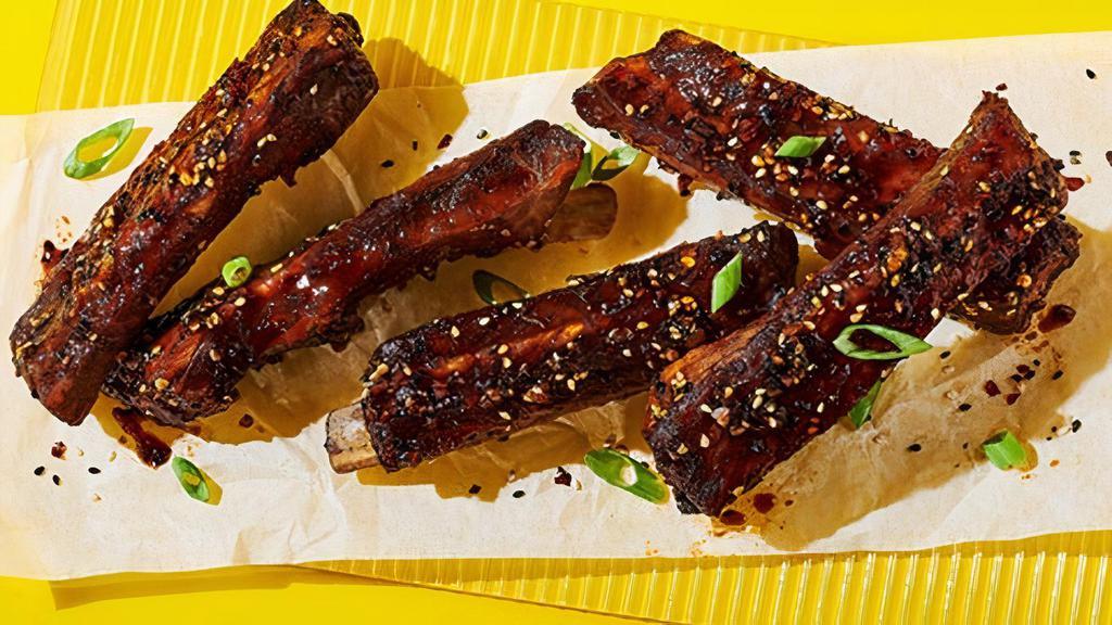 Korean Sticky Ribs · Five pork ribs, spicy Korean BBQ sauce, toasted sesame seeds, green onions