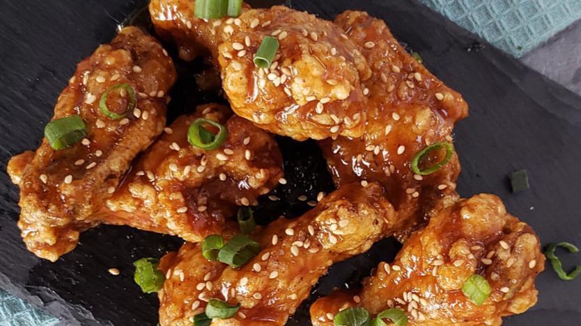 Soy Garlic Wings · Chicken wings infused with soy garlic sauce, green onions, and sesame seeds