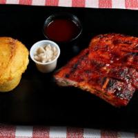 Baby Back Ribs Plate · From the pork loin these ribs are lean and sweet. Smoked and glazed over a hot fire.