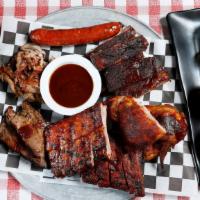 The Belly Buster · Texas BBQ ribs, baby back ribs, lone star BBQ chicken, 18-hour Texas brisket, East Texas pul...