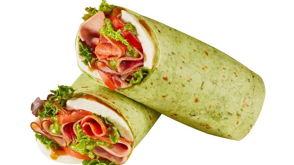Caprese Italian Wrap · Over a 1/4 lb. of our premium, hot Italian meats: mortadella, capicola, Italian dry salami, and black forest ham, with melted mozzarella, fresh spring mix, and sliced tomatoes all drizzled with a basil pesto sauce and balsamic dressing in a spinach tortilla