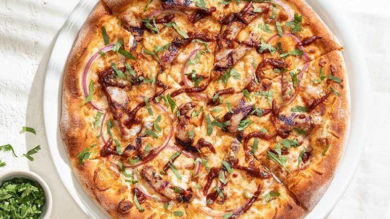 The Original Bbq Chicken Pizza  · Created here in 1985. Our legendary BBQ sauce, smoked Gouda, red onions and fresh cilantro transform this original to iconic. Also available with Nueske's applewood smoked bacon or fresh pineapple. . [Calories listed are per slice. All pizzas are 6 slices.]
