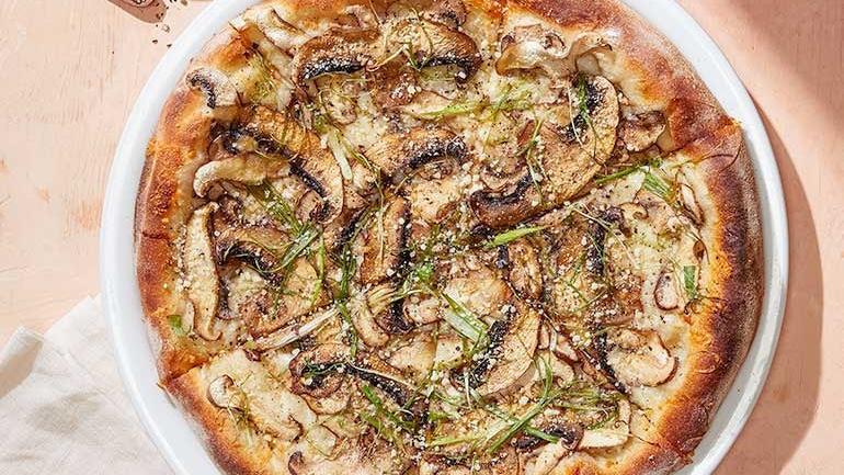 Wild Mushroom · Shaved Cremini, Shiitake, and Portobello mushrooms with slivered scallions, cracked black pepper, Romano and Mozzarella. Finished with Parmesan. Also available with white truffle oil.  . [Calories listed are per slice. All pizzas are 6 slices.]