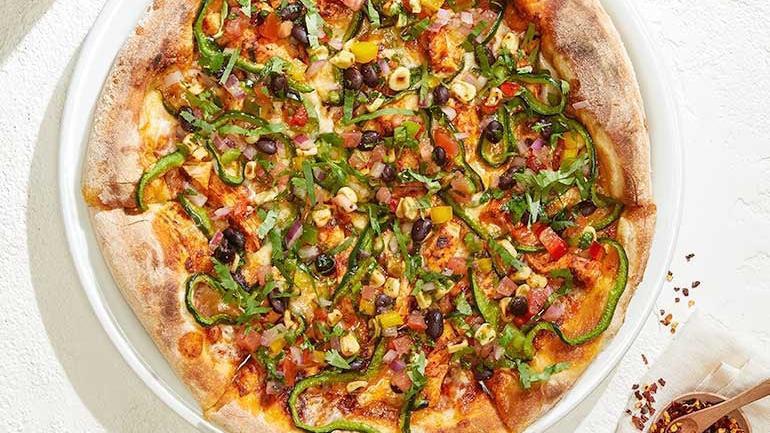Spicy Chipotle Chicken · Chipotle adobo sauce, shaved poblanos and Monterey Jack with housemade roasted corn & black bean salsa, fresh cilantro and tangy lime crema.. [Calories listed are per slice. All pizzas are 6 slices.]