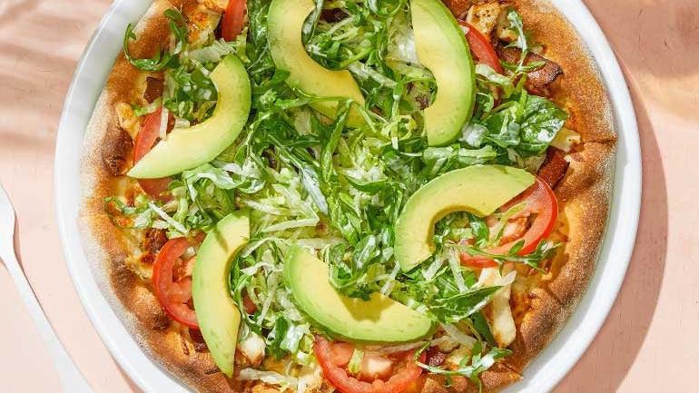 California Club · Nueske's applewood smoked bacon, grilled chicken and Mozzarella, hearth-baked then topped with avocado, wild arugula, fresh tomatoes, torn basil and Romaine tossed in lemon-pepper mayo. . [Calories listed are per slice. All pizzas are 6 slices.]