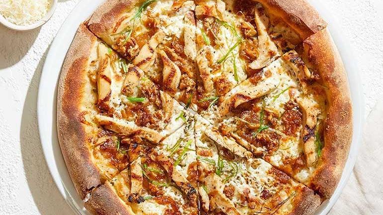 Roasted Garlic Chicken · Sweet caramelized onions, fresh Mozzarella, Parmesan, slivered scallions and cracked black pepper.  Suggested on cauliflower crust.. [Calories listed are per slice. All pizzas are 6 slices.]