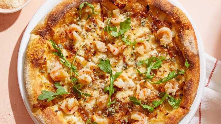 Shrimp Scampi Pizza · Housemade lemon-garlic shrimp with caramelized onions, Mozzerella, Parmesan and red chili, topped with fresh arugula and wild Greek oregano.  Suggested on cauliflower crust.. [Calories listed are per slice. All pizzas are 6 slices.]