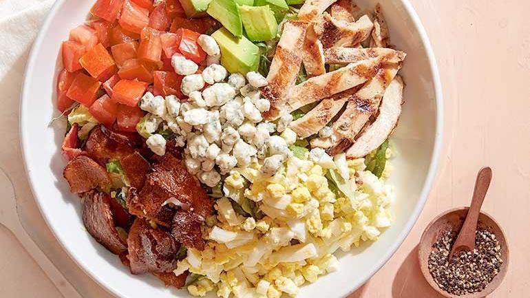 California Cobb · Nueske's applewood smoked bacon, avocado, chicken, tomatoes, chopped egg, fresh basil and Gorgonzola. Served with housemade herb ranch or bleu cheese dressing.