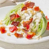 Petite Wedge · Topped with bleu cheese dressing, Nueske's applewood smoked bacon, chopped egg and Roma toma...