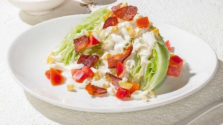 Petite Wedge · Topped with bleu cheese dressing, Nueske's applewood smoked bacon, chopped egg and Roma tomatoes.