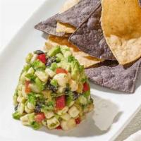 White Corn Guacamole + Chips · Diced avocado, sweet white corn, black beans, jicama, bell peppers, fresh cilantro and serra...