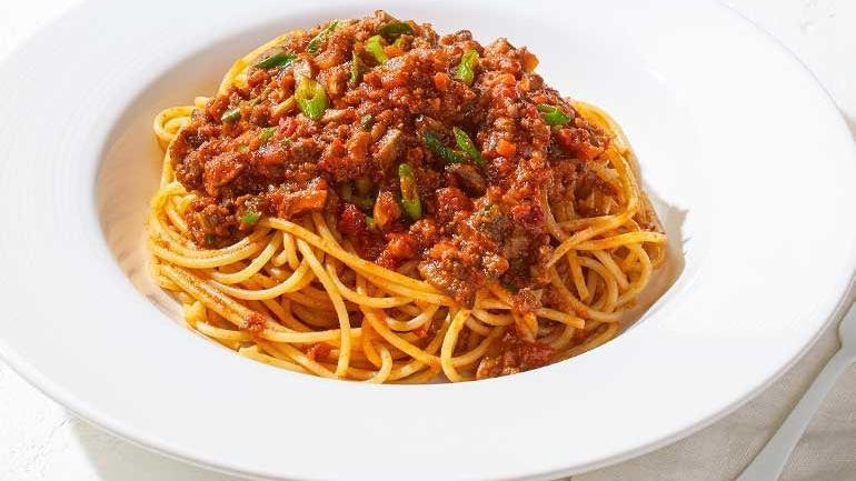 Bolognese Spaghetti · With Cremini mushrooms, sprinkled with scallions.